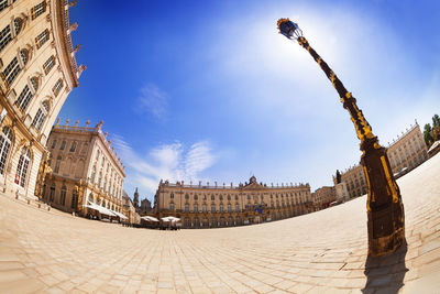 Low angle view of buildings in town against sky