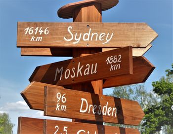 Low angle view of road sign against sky