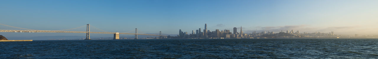 View of suspension bridge with city in background