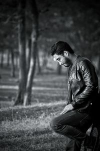 Side view of young man standing on field