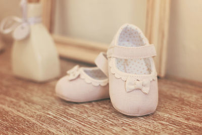 Close-up of shoes on wooden floor