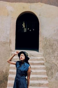 Woman standing against wall