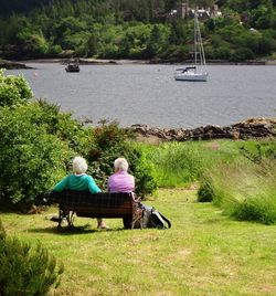 People sitting on boat in river