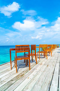 View of wooden pier at beach against sky