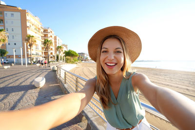 Vacation in calabria. selfie girl on crotone promenade in calabria, southern italy.