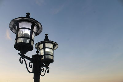 Low angle view of street light against sky