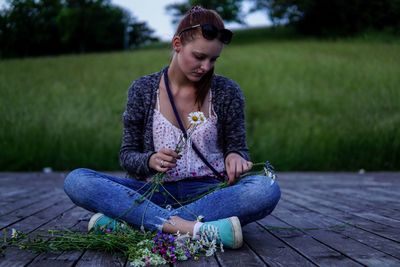 Young woman sitting on field