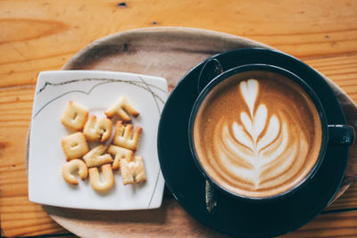 High angle view of cappuccino served on table