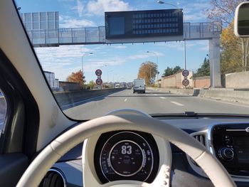 Car on road seen through windshield