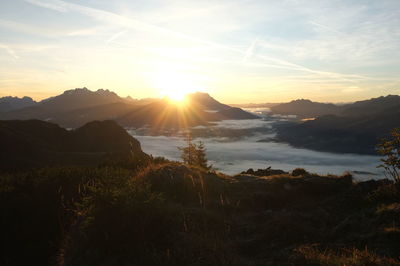 Scenic view of sunset over mountains