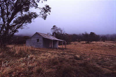 Houses on field against sky