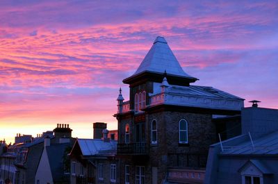 Low angle view of building against sky at sunset