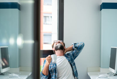 Tired man sitting in office