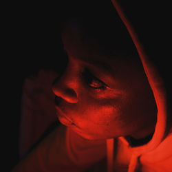 Close-up of young man against black background