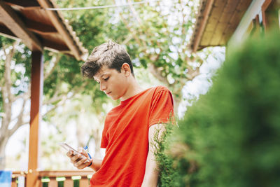 Young man using mobile phone outdoors