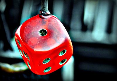 Close-up of red bell hanging outdoors