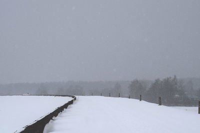 Snow covered field against sky