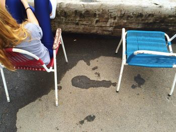 High angle view of woman resting on chair