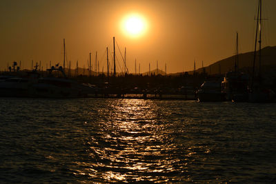 Sailboats in marina at sunset