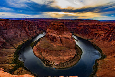 Scenic view of rock formations against cloudy sky