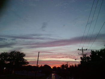 Low angle view of silhouette trees against sky during sunset