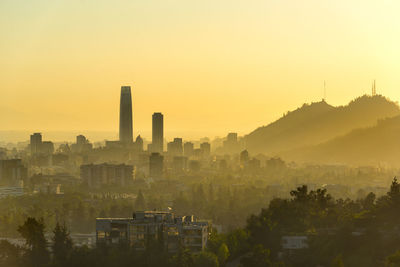 A silhouetted panoramic view of santiago de chile at sunset.