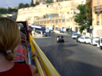 Rear view of women looking at city street