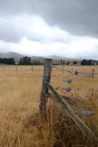 Hay bales on field against sky