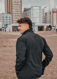 Rear view of man standing at beach