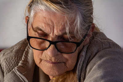 Close-up portrait of woman wearing eyeglasses