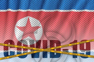 Close-up of heart shape on pink paper over white background