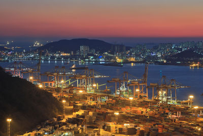 High angle view of illuminated buildings against sky at night