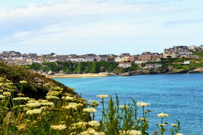 View of town by sea against sky