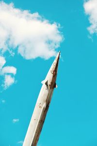 Low angle view of airplane flying against blue sky