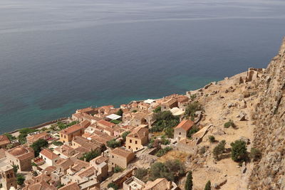 High angle view of buildings by sea