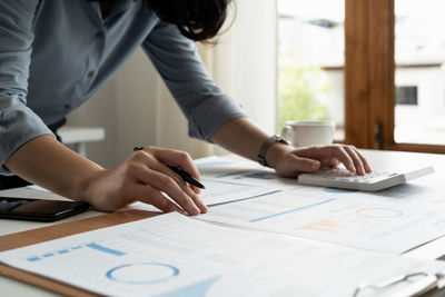 Midsection of business colleagues working at office