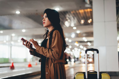 Side view of woman using mobile phone