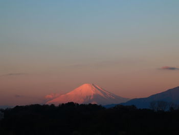 Scenic view of silhouette mountains against sky during sunset