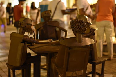 Close-up of chairs on table