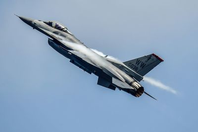 Low angle view of airplane flying against clear sky