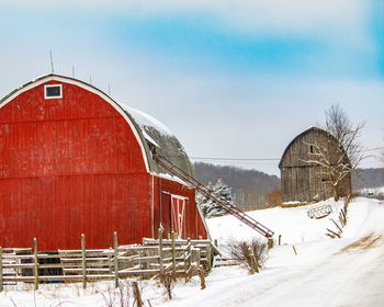 Abandoned snow covered field against sky