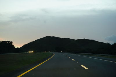 Empty road passing through mountains