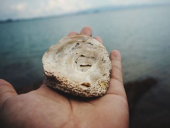 Close-up of person hand holding sea water