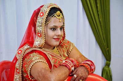 Close-up of bride against curtains