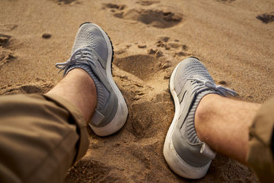 Low section of man on sand