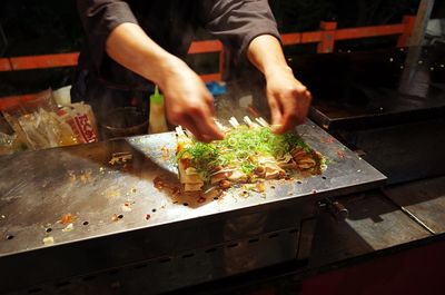 Midsection of man preparing food