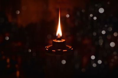 Close-up of lit candles in the dark