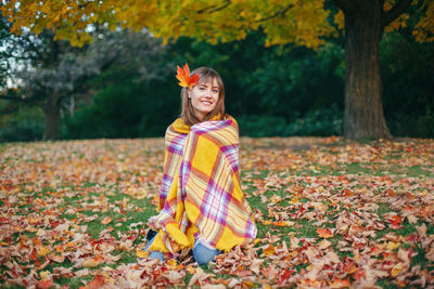 Portrait of a smiling boy with autumn leaves