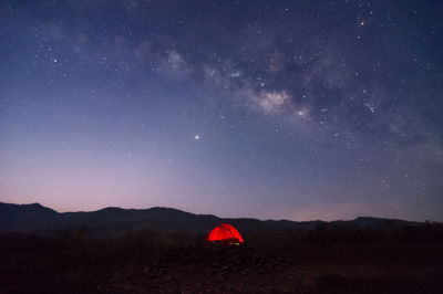 Red tent in reservoir under milky way , long speed exposure. baan sop pat, mae moh lampang thailand.