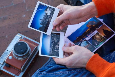 Midsection of person photographing with mobile phone